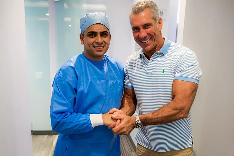Dr. Dalla with his patient shaking hands