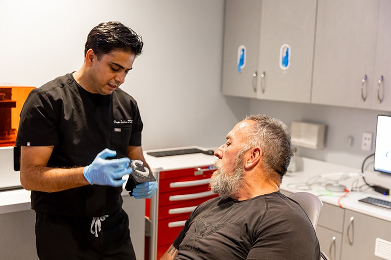 Dr. Dalla during dental consultation with his patient