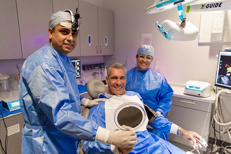 Dr. Dalla with his patient during dental procedure