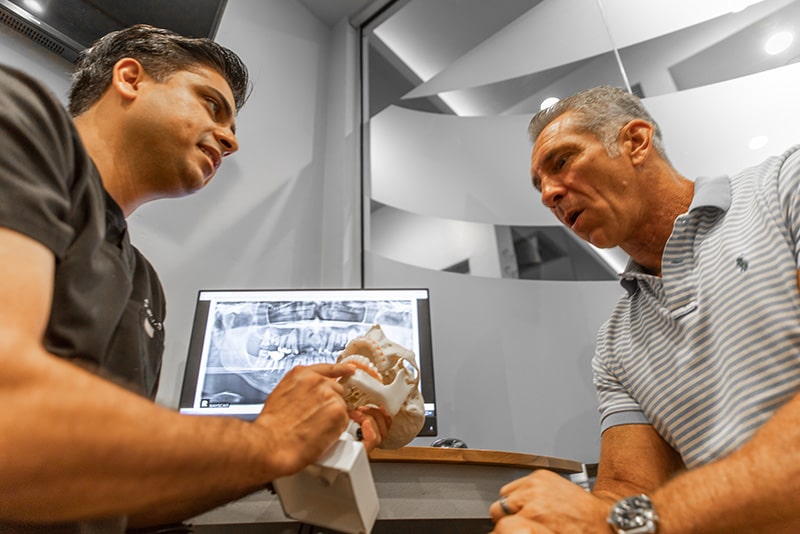 Dr. Dalla showing Zygomatic Implants to his patient